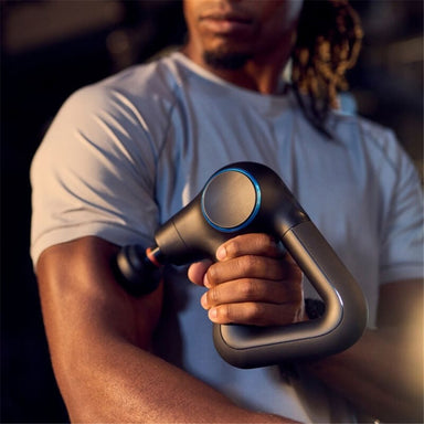 man using therabody theragun prime plus massage gun