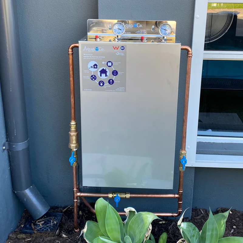 Two stage water filter system with cover installed at home