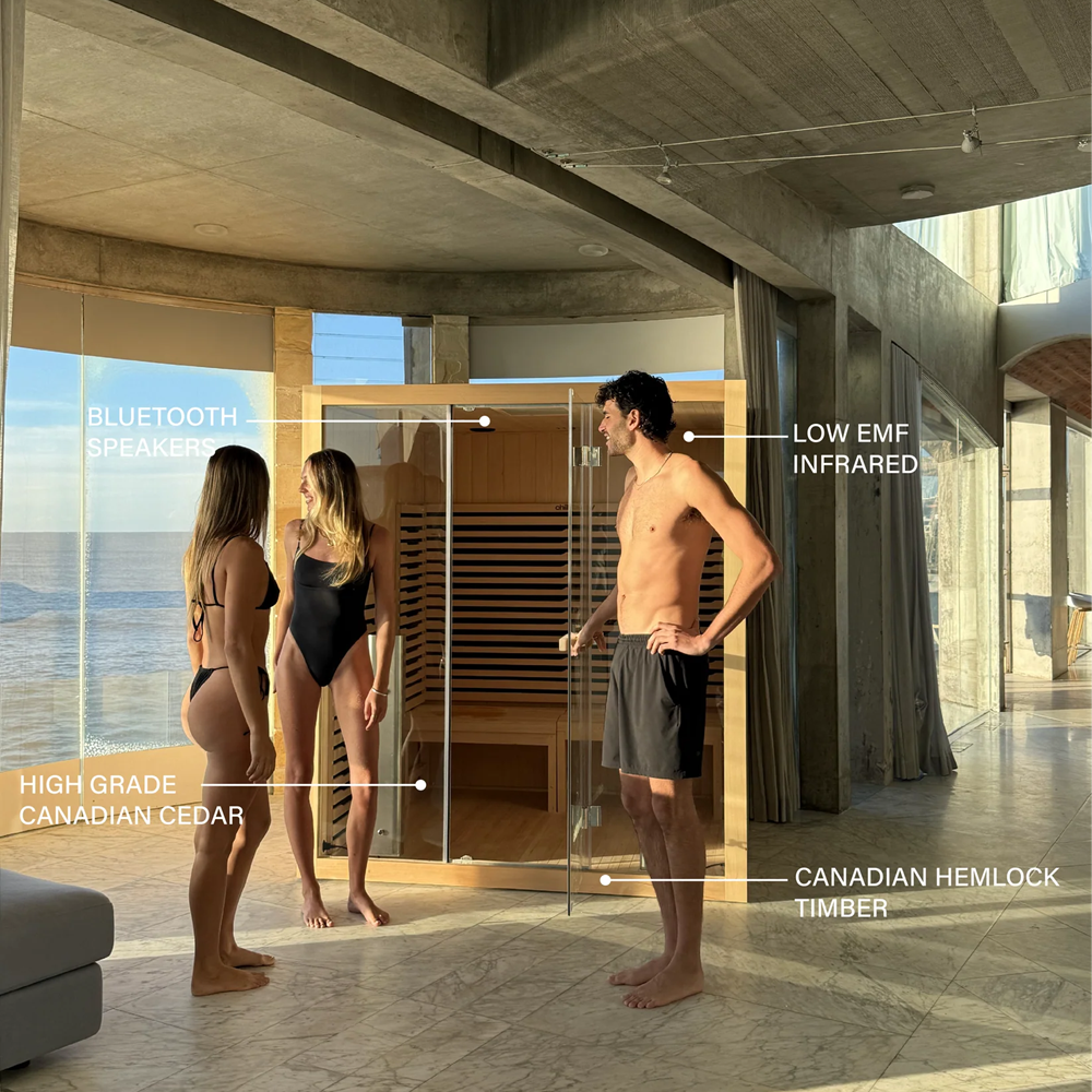 Chill Bunny indoor infrared sauna with glass door and three people inside a modern room by the ocean