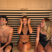 Three people enjoying a Chill Bunny indoor infrared sauna with wooden interior seating