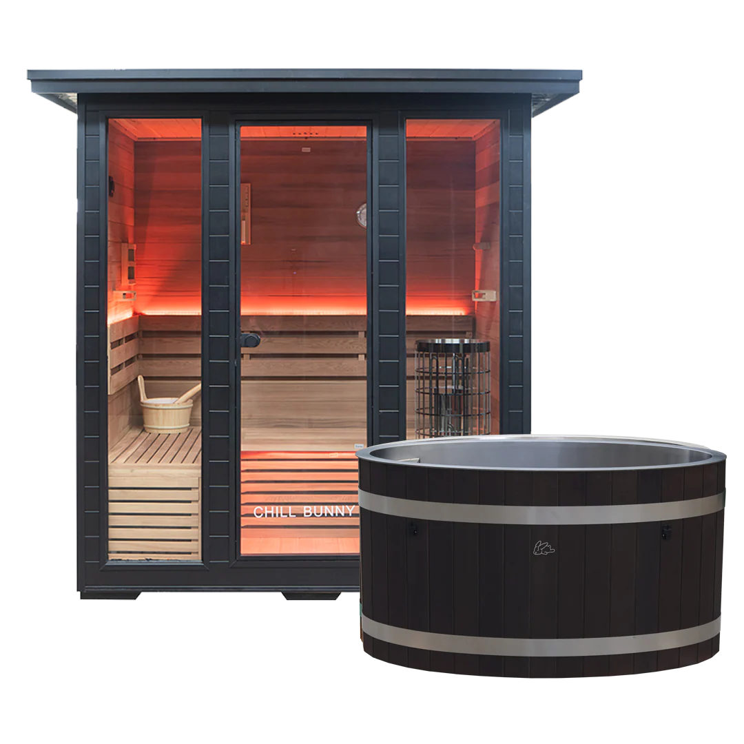 Chill Bunny sauna with black frame and wooden interior glowing with warm lights next to a matching black ice bath