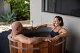 Two people in an oval ice bath