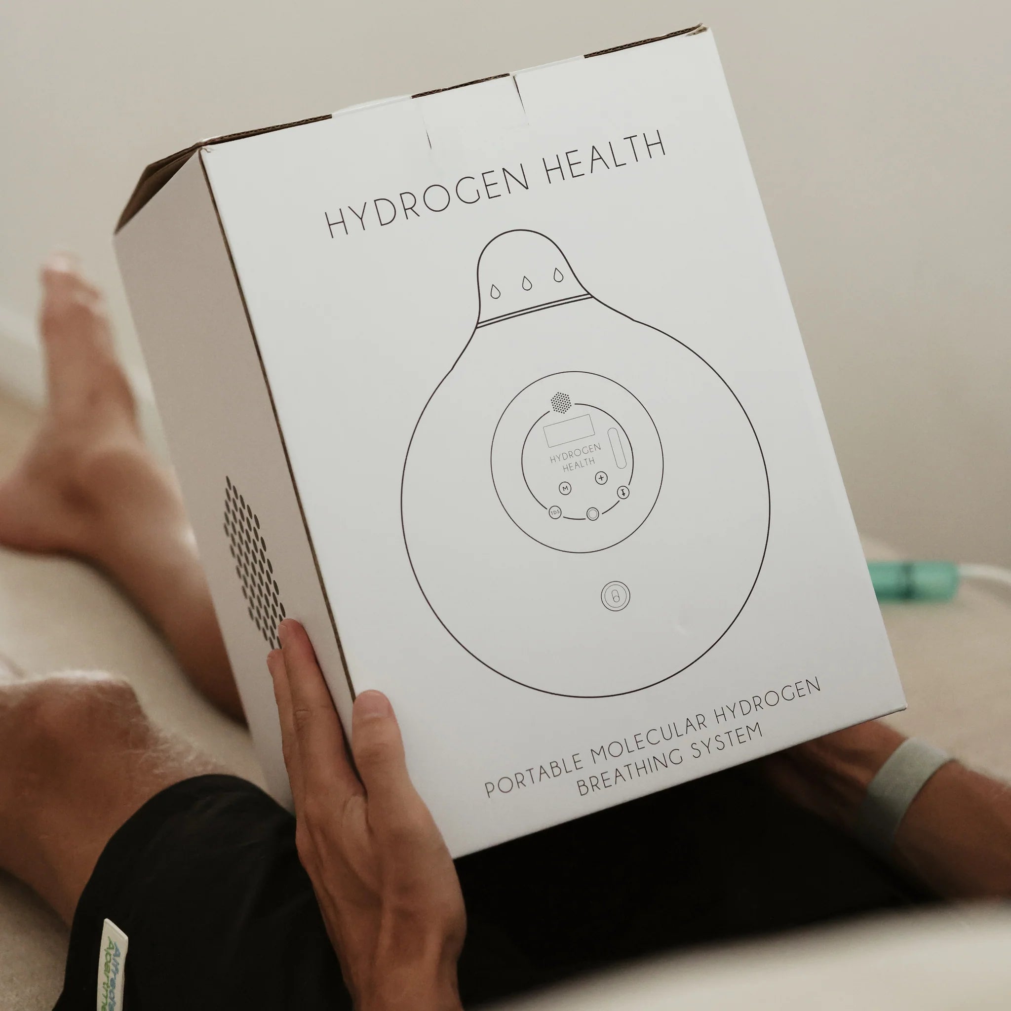 Hydrogen Health portable hydrogen breathing system packaging held by person lying down