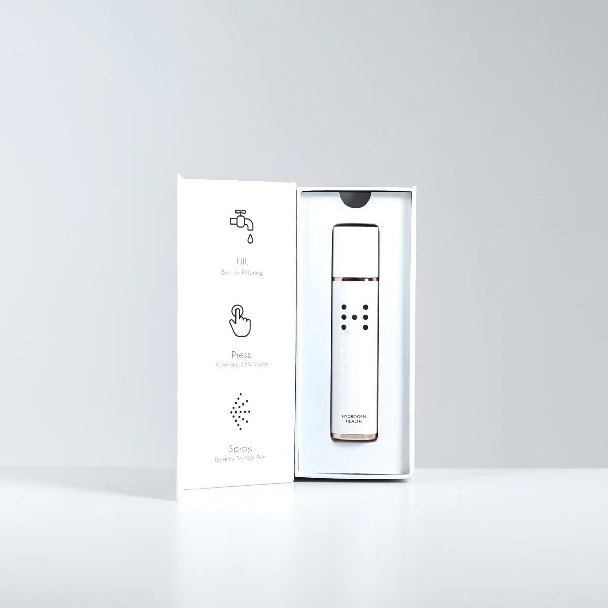 Hydrogen Health hydrogen skin mister in white with rose gold accents displayed in an open box