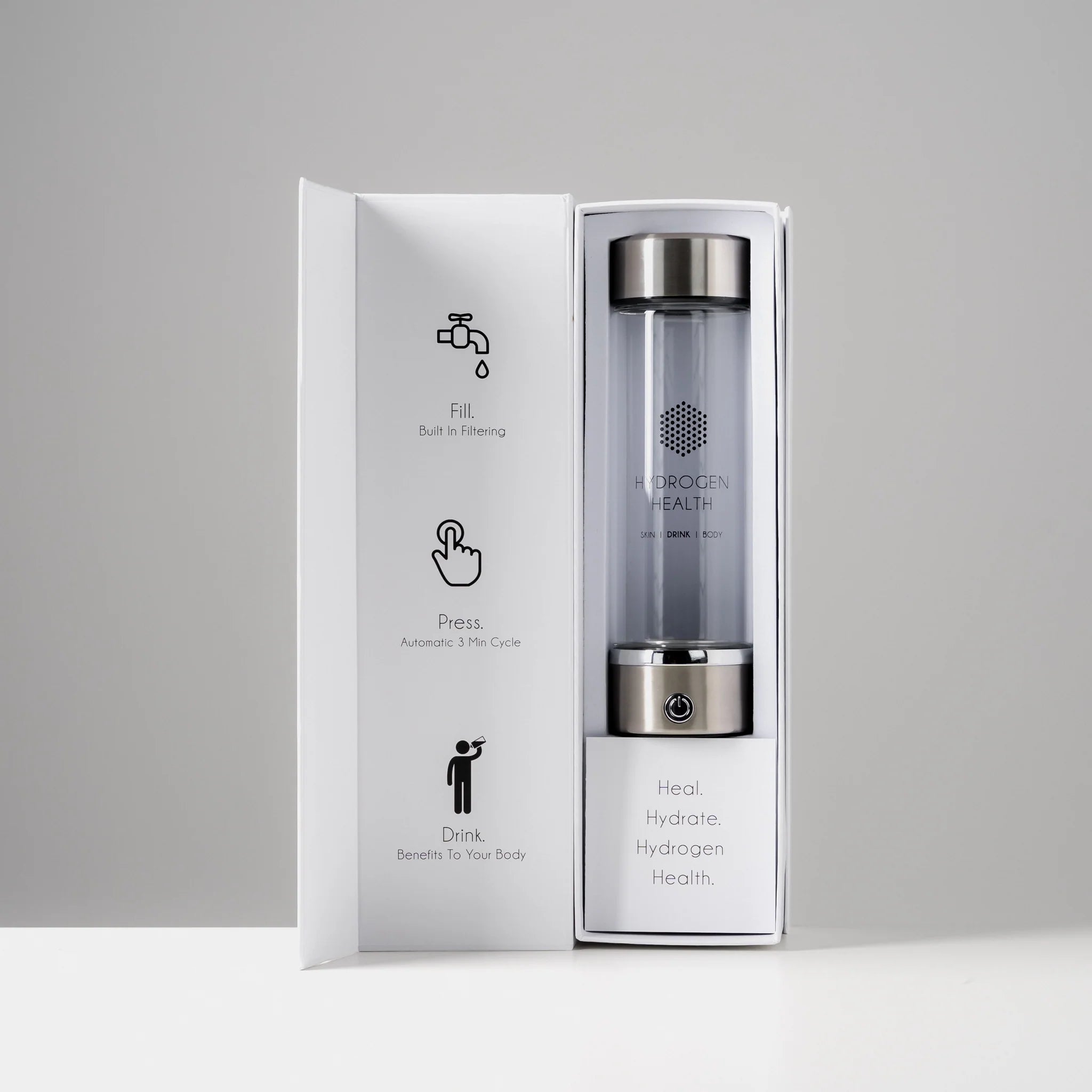 Hydrogen Health branded hydrogen water bottle with sleek silver caps in white open packaging