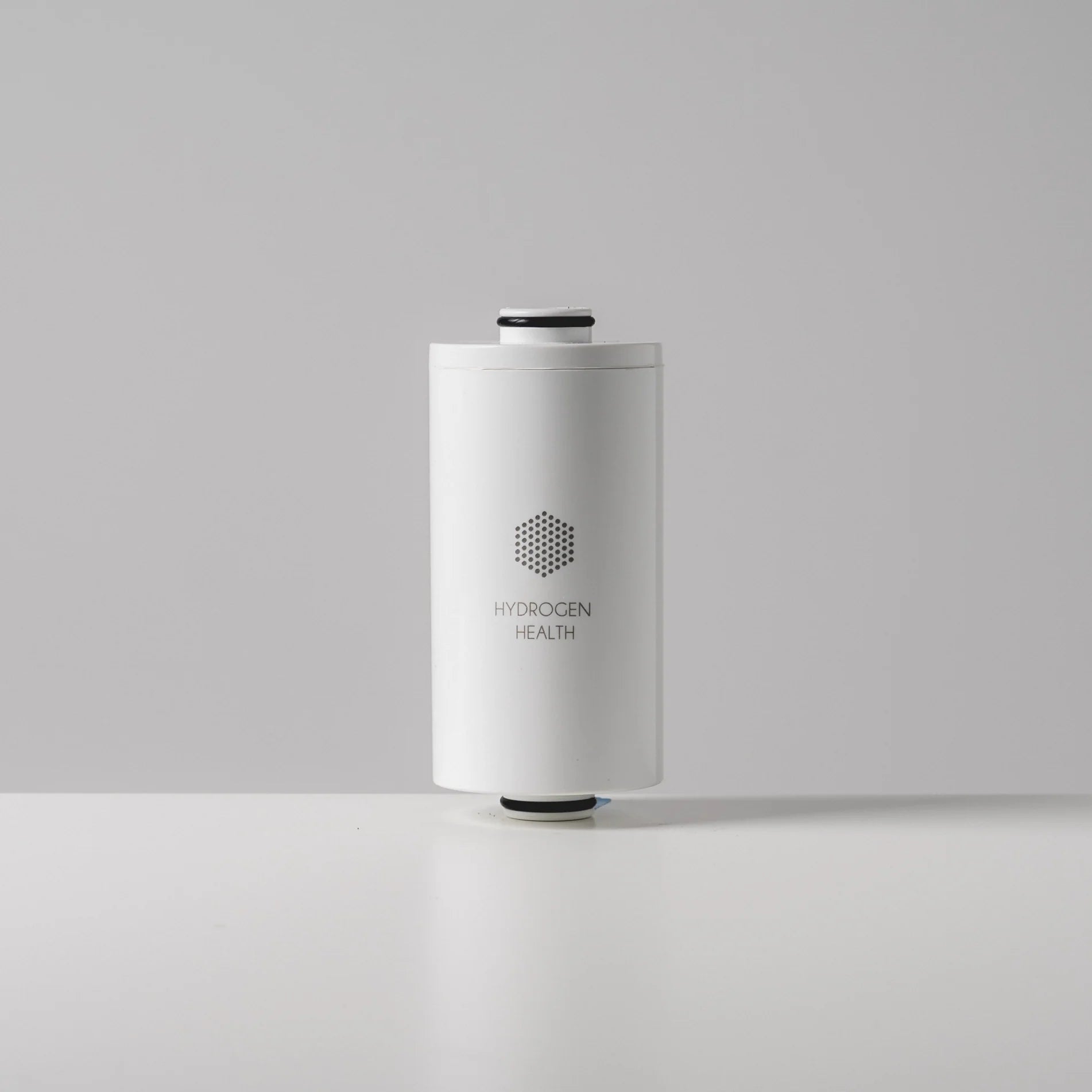 Hydrogen Health white hydrogen personal care shower filter replacement cartridge on gray background