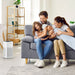 Ionmax air purifier placed in living room with happy family sitting on gray sofa