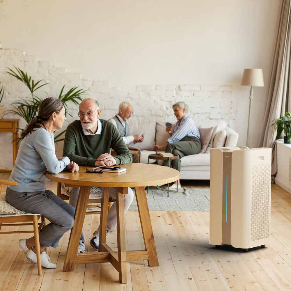 Ionmax air purifier in a living room with elderly people sitting and conversing around a wooden table