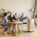 Ionmax air purifier in a living room with elderly people sitting and conversing around a wooden table