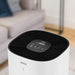 Ionmax white air purifier with digital display and black top grill in living room setting