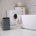 Ionmax gray dehumidifier placed on white floor in bathroom near bathtub and washing machine