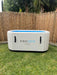 large white frozen oasis ice bath in backyard