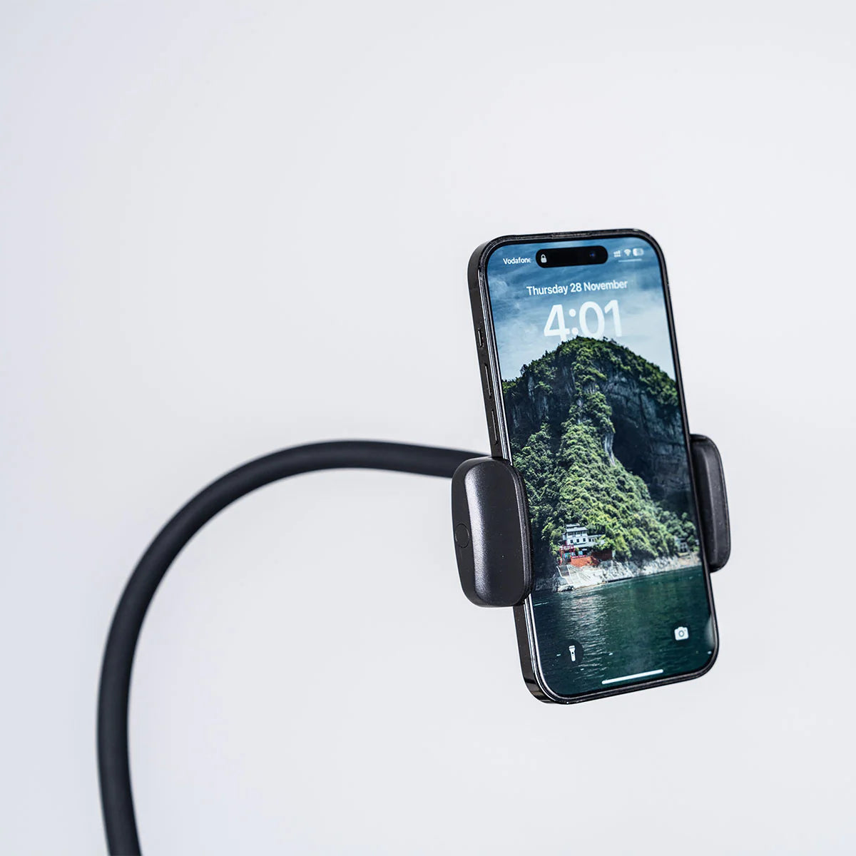 Flexible phone holder attached to Lifespan Fitness massage chair for hands-free device use