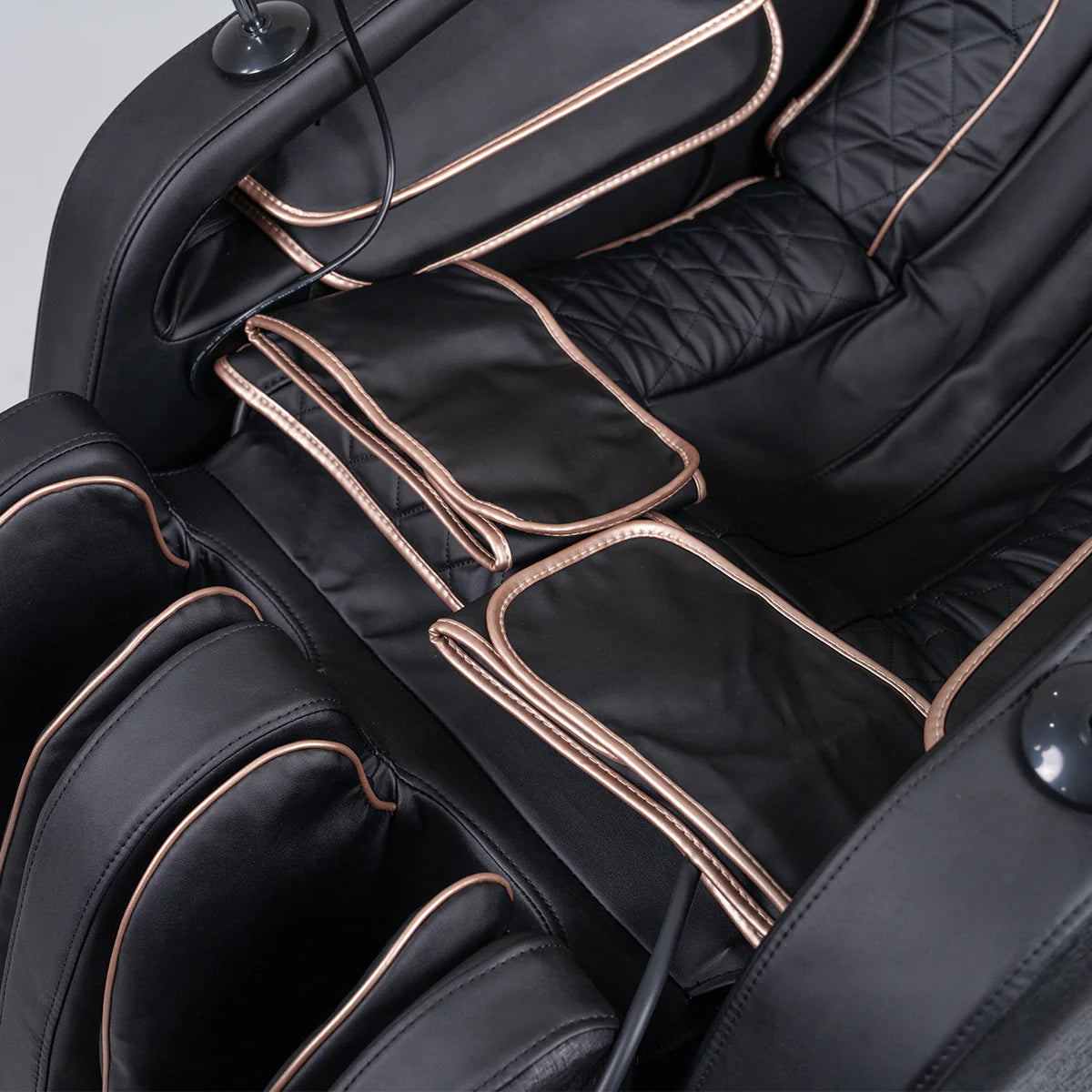 Lifespan Fitness black massage chair with padded cushions and gold trim detailing