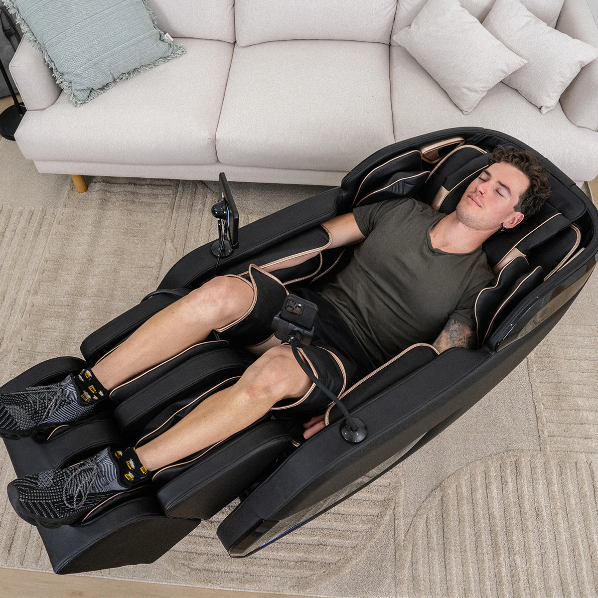 Lifespan Fitness massage chair in black with a man relaxing with full-body leg and neck massage features