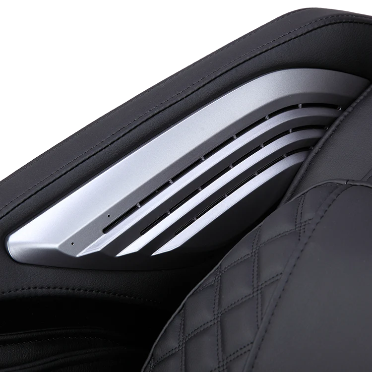 Close-up of black Masseuse massage chair armrest with silver accents and quilted leather upholstery