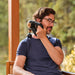 Man using Therabody massage gun on neck muscles for deep tissue relief at home