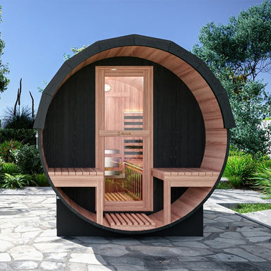 Nuvie outdoor barrel sauna with wooden interior and black exterior placed on stone patio