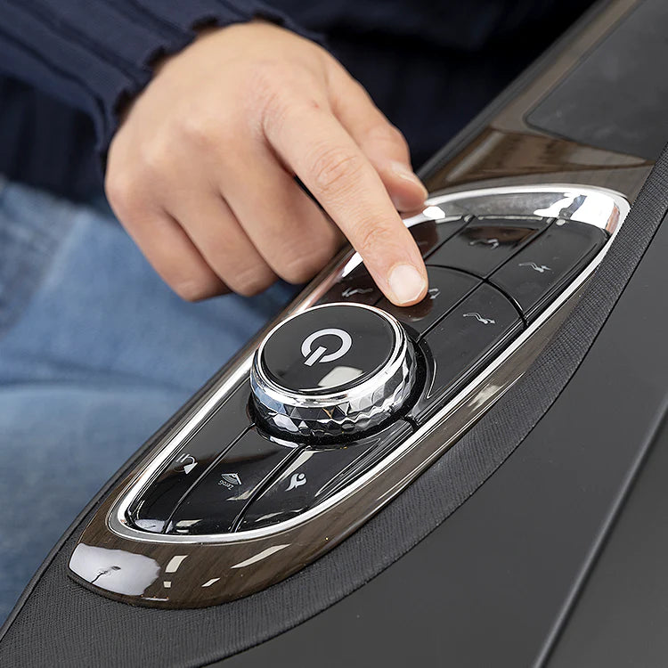 Close-up of hand adjusting control panel on Masseuse massage chair with power button and settings
