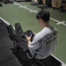 Person using Lifespan Fitness compression boots with digital control panel on a gym bench