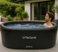 Man relaxing in a Lifespan Fitness ReGen8 black inflatable ice bath outdoors on patio