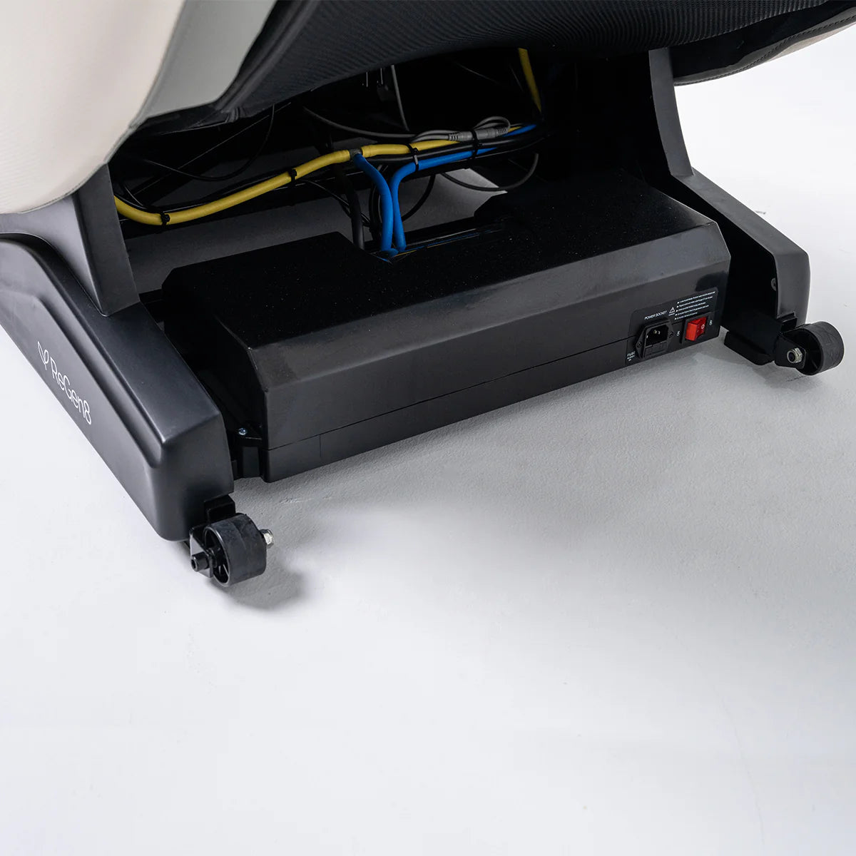 Bottom view of Lifespan Fitness massage chair showing wheels and internal wiring details