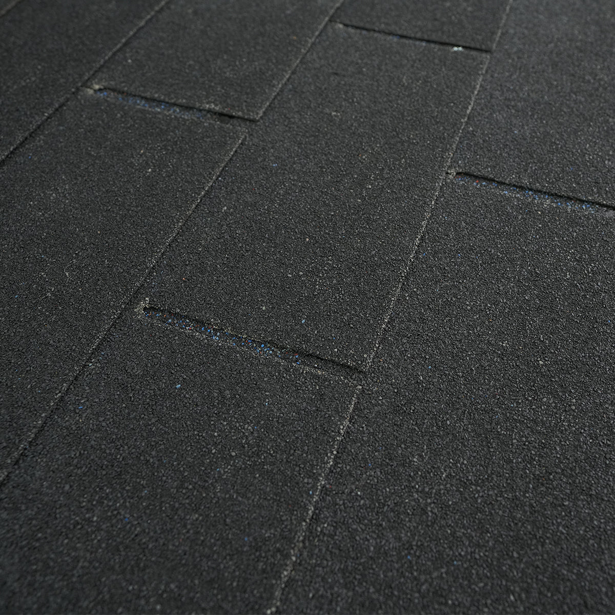 Close-up of Lifespan Fitness sauna textured black floor tiles with interlocking design