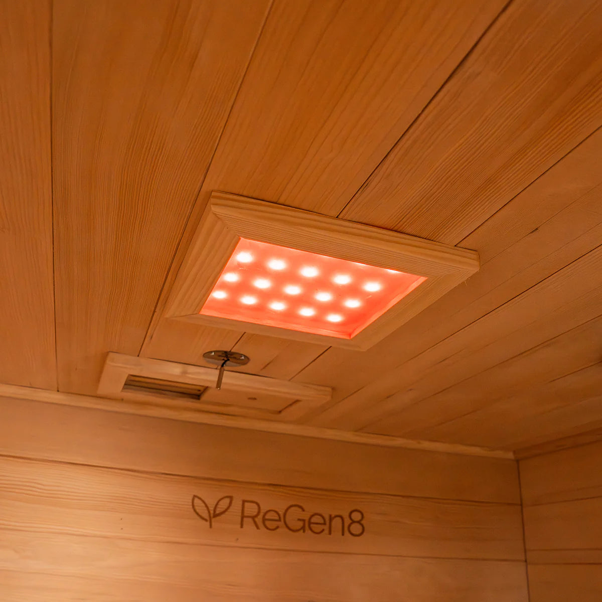 Lifespan Fitness sauna interior wooden ceiling with soft red LED lights and ReGen8 logo on wall