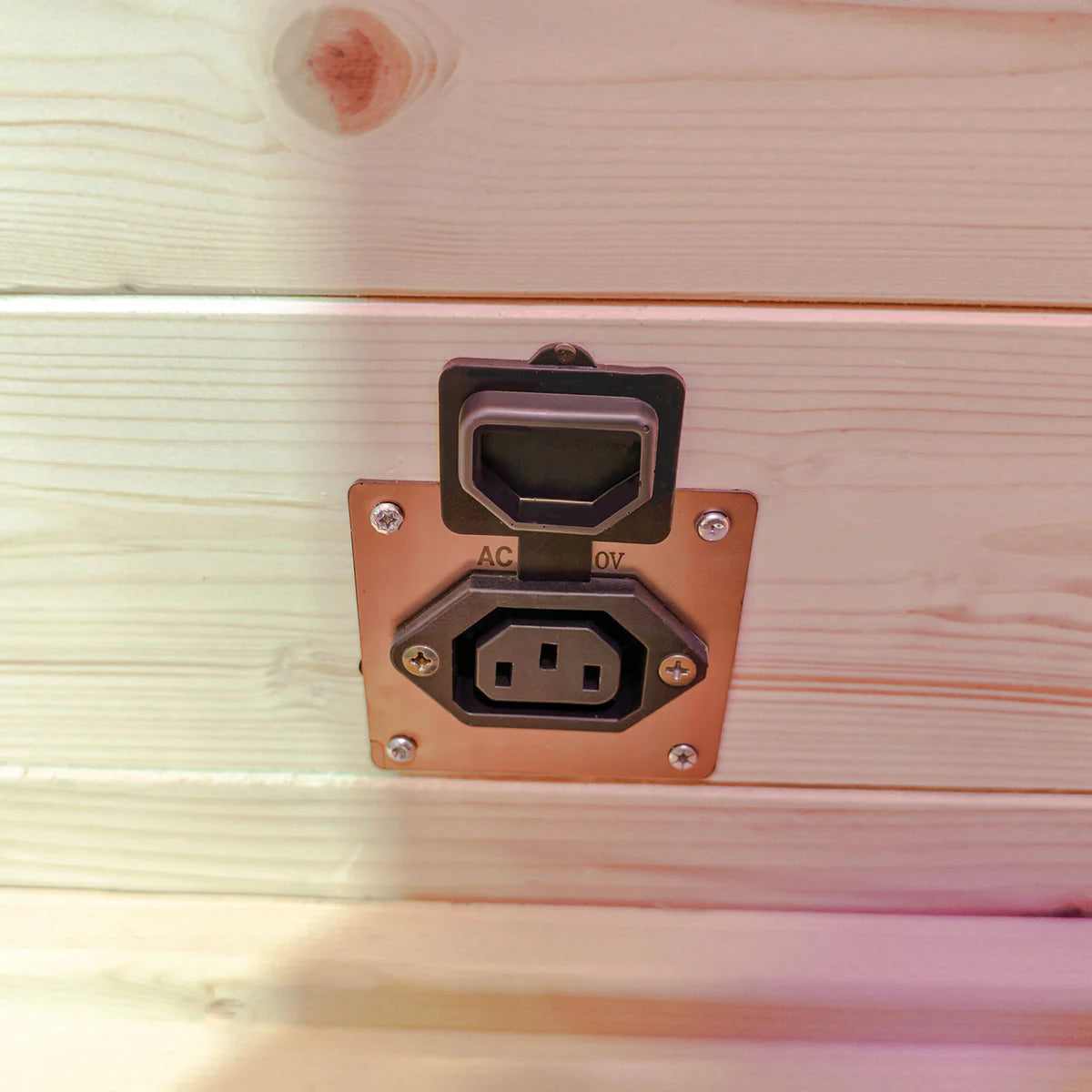 Power outlet panel inside Lifespan Fitness sauna with protective cover on wooden wall