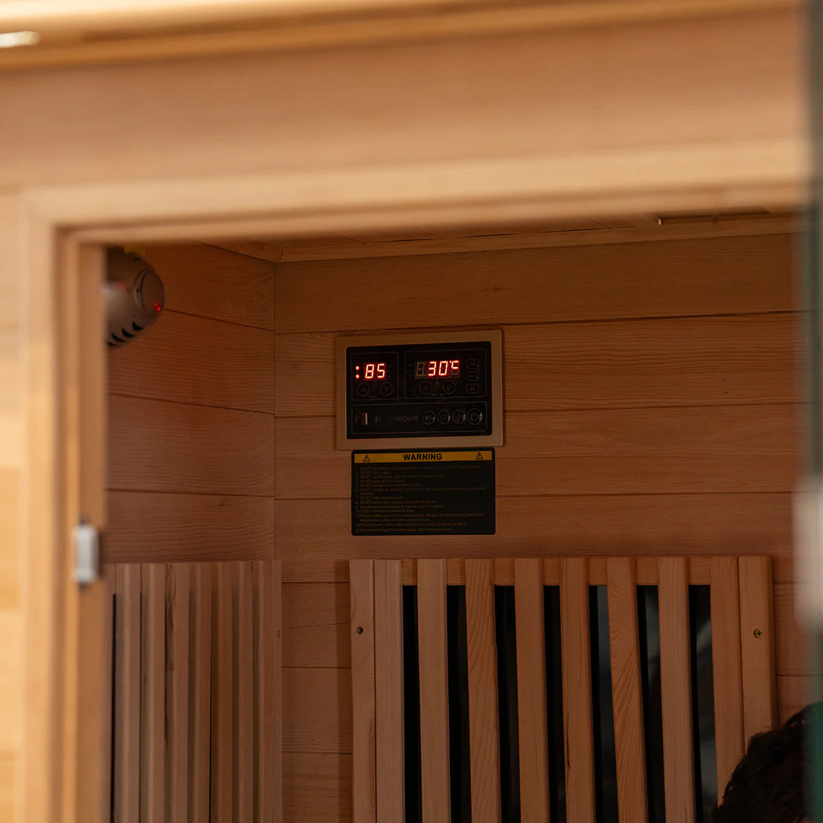 Lifespan Fitness sauna interior with wooden bench and digital control panel displaying temperature