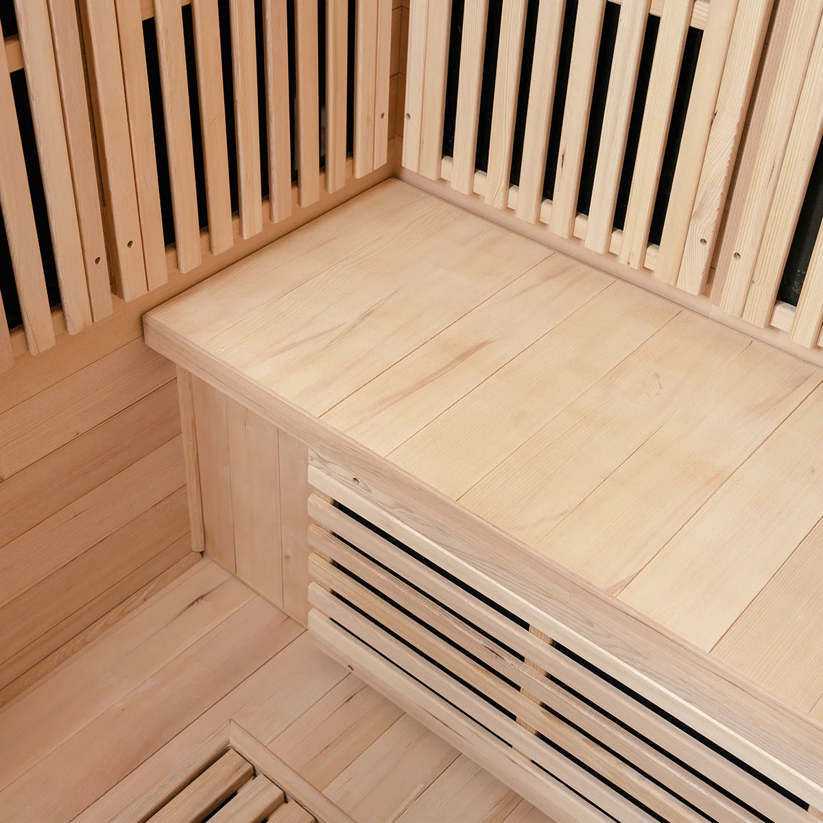 Interior corner of Lifespan Fitness wooden sauna with smooth bench and slatted walls