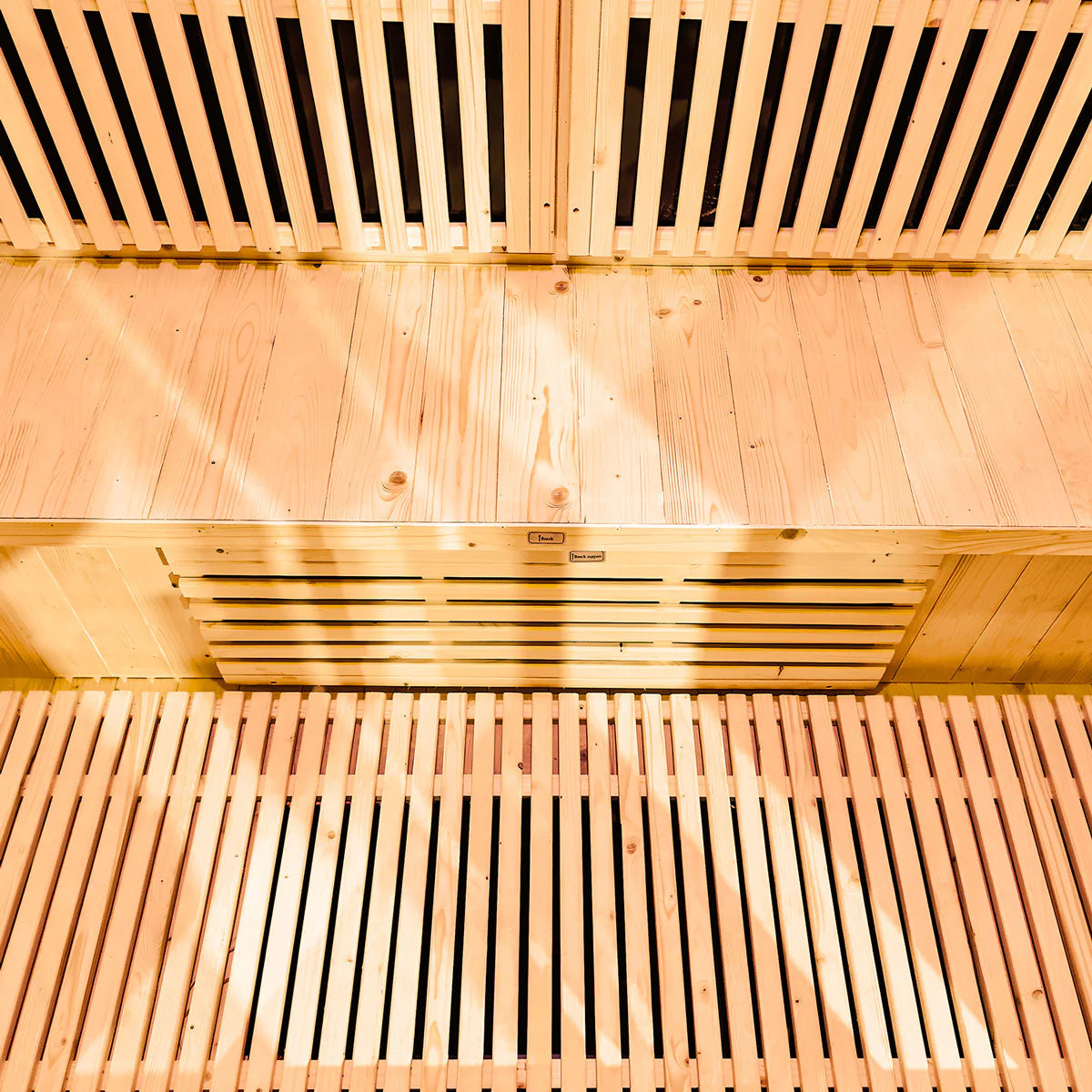 Lifespan Fitness wooden sauna interior with slatted benches and warm lighting