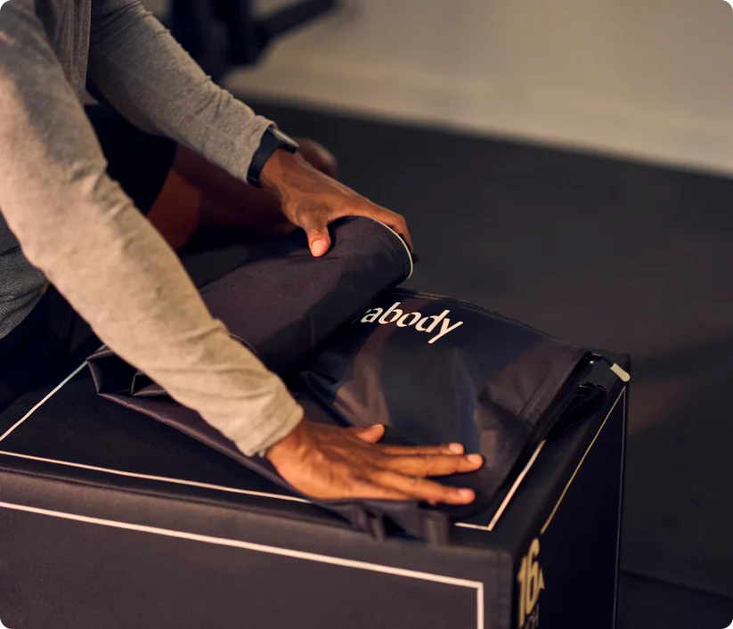 Therabody compression boots being adjusted on legs for muscle recovery and improved circulation