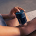 Therabody hot and cold therapy black cupping device applied to forearm for muscle relief