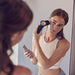 woman using therabody theraface pro in black