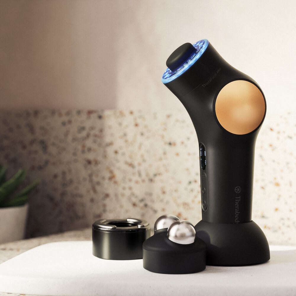Therabody theraface pro skincare device with multiple attachments on a countertop