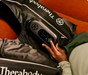 man using therabody jetboots prime compression boots on couch