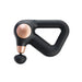 Therabody massage gun in black and rose gold with ergonomic triangular handle and round attachment