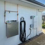 Premium whole house three stage water filtration system mounted to outdoor wall