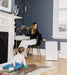 Welcare air purifier in white placed next to a woman sitting on chair and child playing on rug in modern living room