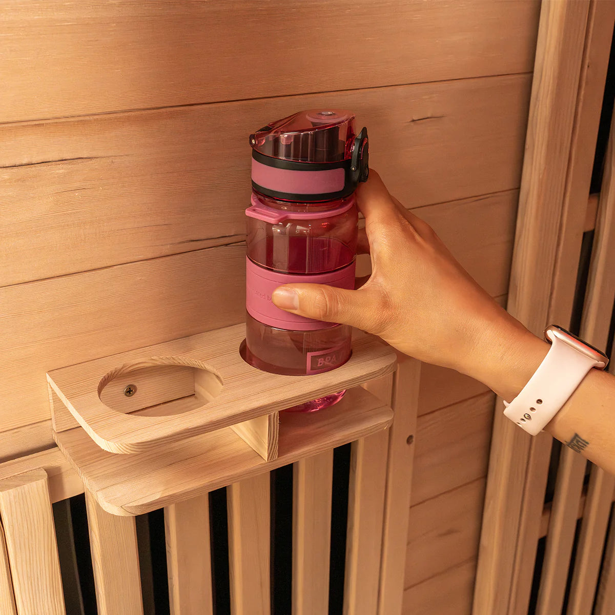 Lifespan Fitness sauna wooden shelf holding a pink water bottle inside a sauna room